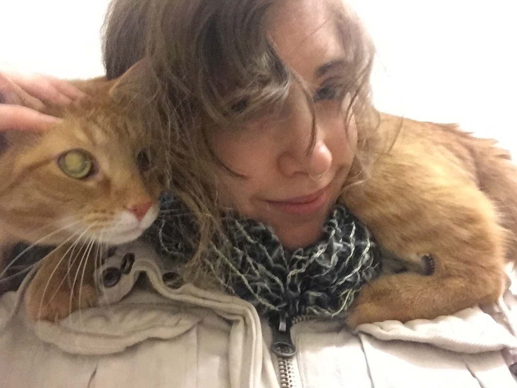 Me with my orange tabby cat, Leia, draped across my shoulders